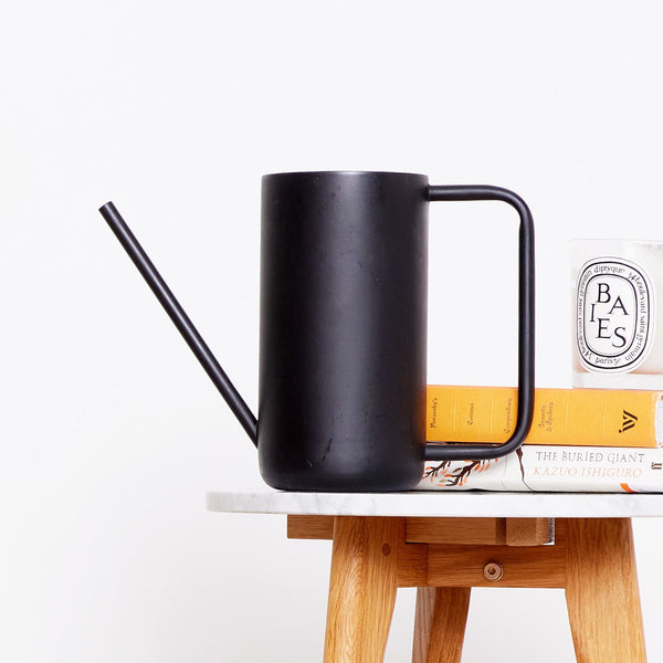 A black Patch watering can